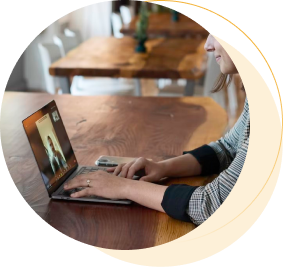 person watching training on laptop at table